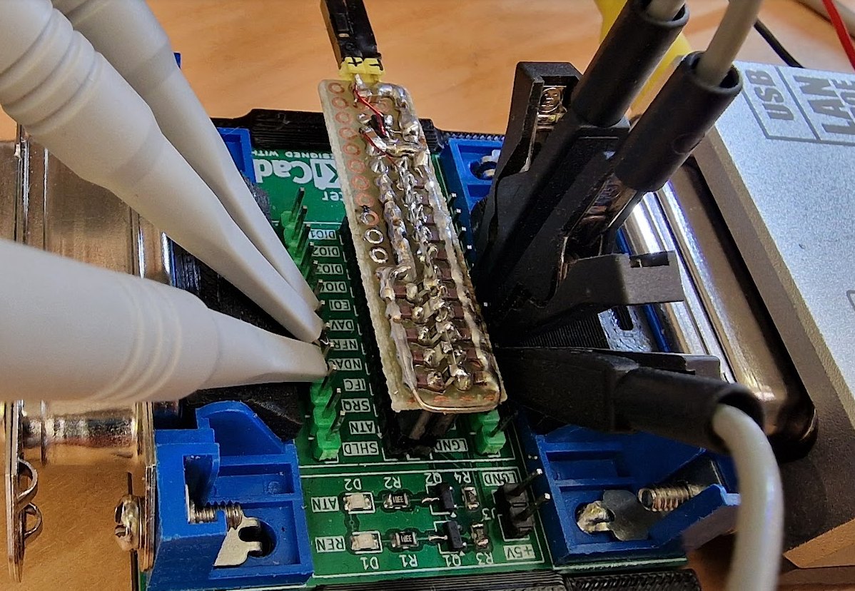 A GPIB breakout board on the bench with oscilloscope probes attached to individual bus lines, with GPIBee connected, for measuring bus loading and handshake timing